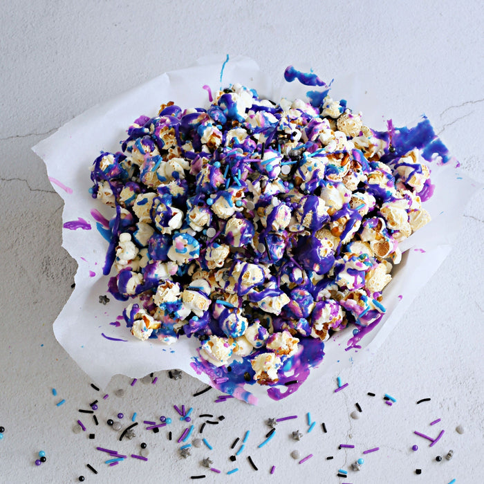 Galaxy colored popcorn in a bowl.