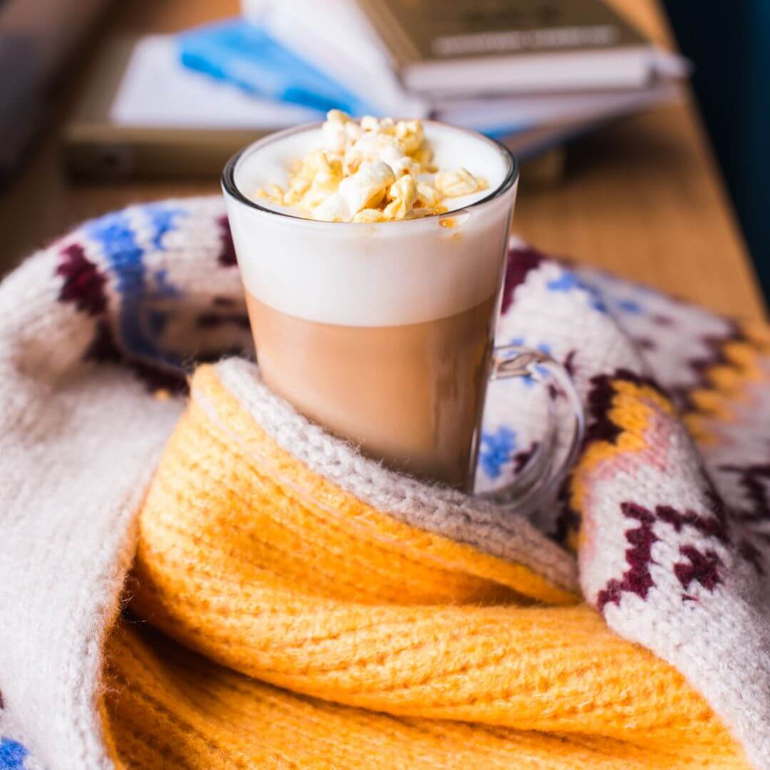 Caramel popcorn latte topped with freshly popped popcorn and salted caramel seasoning