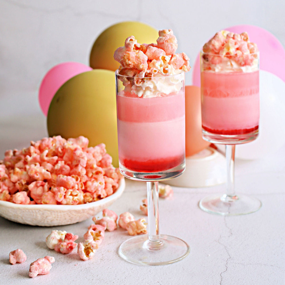 Pink gin layered cocktail shots with pink candied popcorn for a bridal shower party