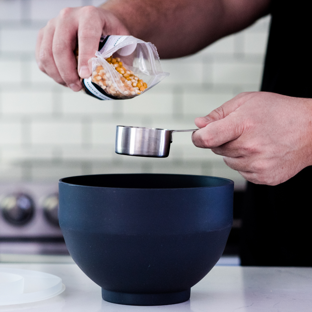 Dell Cove Spices popcorn being poured into measuring cup