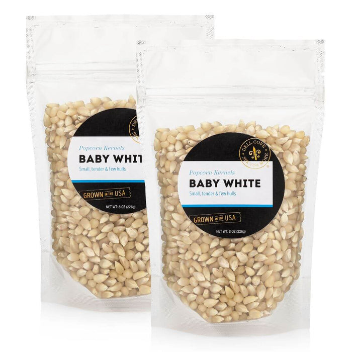 Two half-pound pouches of Dell Cove Baby White popcorn kernels, sold together as the 1-pound option