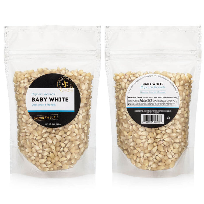 Front and back of Dell Cove Baby White popcorn kernels half-pound pouch with Nutrition Facts