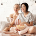 Two young women eating a bowl of baby white popcorn - dell cove spices