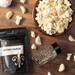Buttery Garlic popcorn seasoning with garlic and empty spice jar and popcorn - dell cove spices