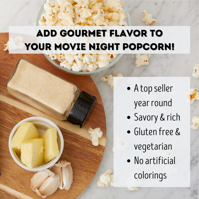 Buttery Garlic popcorn seasoning on wooden tray with popcorn and butter and garlic cloves - dell cove spices