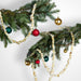 Decorative Christmas popcorn garland with ornaments on a white background
