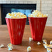 Set of two Crate & Barrel red scalloped melamine popcorn cups filled with popcorn