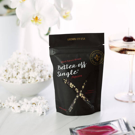 Glass of wine and bowl of Dell Cove Better Off Single popcorn – relaxing self-care night for single women