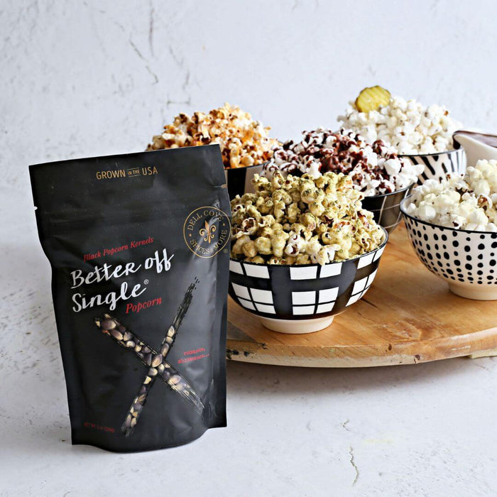 Self-care gift for women — Better Off Single® Popcorn Kit with popped popcorn and cozy movie night setup.
