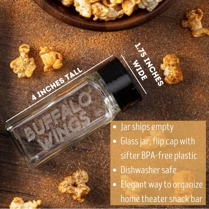 Glass jar for storing Buffalo Wings popcorn seasoning on a wooden surface with popcorn and spices.