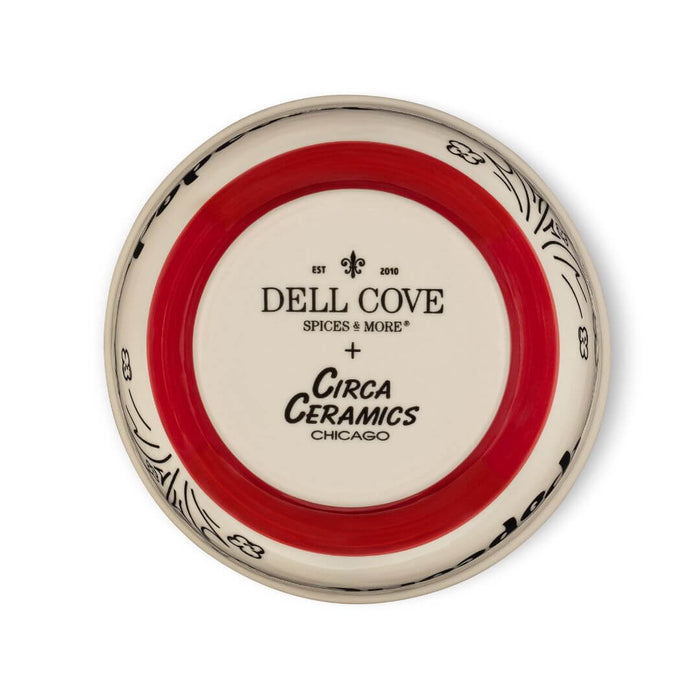 Close-up of bottom of Dell Cove® ceramic popcorn bowl showing red and white exterior glaze and company logos