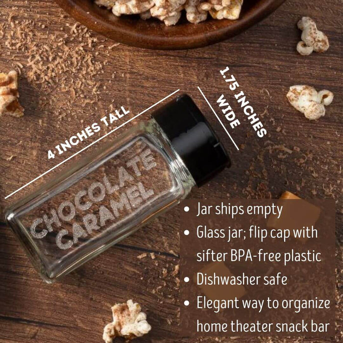 Glass spice jar etched Chocolate Caramel for chocolate caramel popcorn seasonings on a wooden surface with popcorn and chocolate and caramel pieces.
