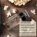 Glass jar used for storing Kettle Corn popcorn seasoning with popped popcorn on a wooden surface