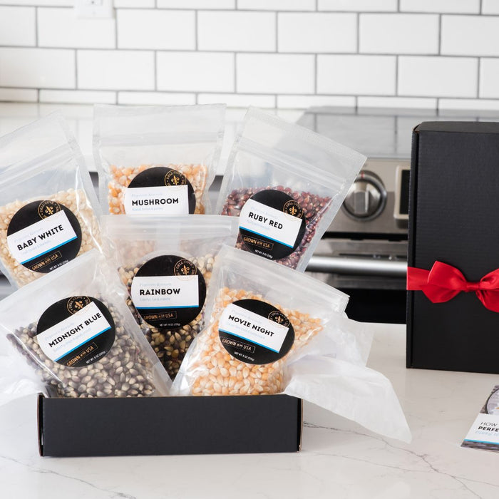 Six best-selling popcorn kernels — Classic Movie, Mushroom, Baby White, Midnight Blue, Rainbow, Ruby Red popcorn kernels in a black gift box