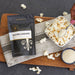 Bowl of popcorn topped with Dell Cove Salted Caramel popcorn seasoning – sweet and salty movie snack