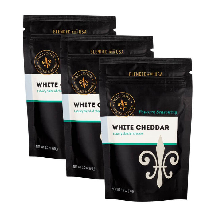 Three package bundle of Dell Cove gluten free White Cheddar popcorn seasoning with a visible brand logo on a white background.