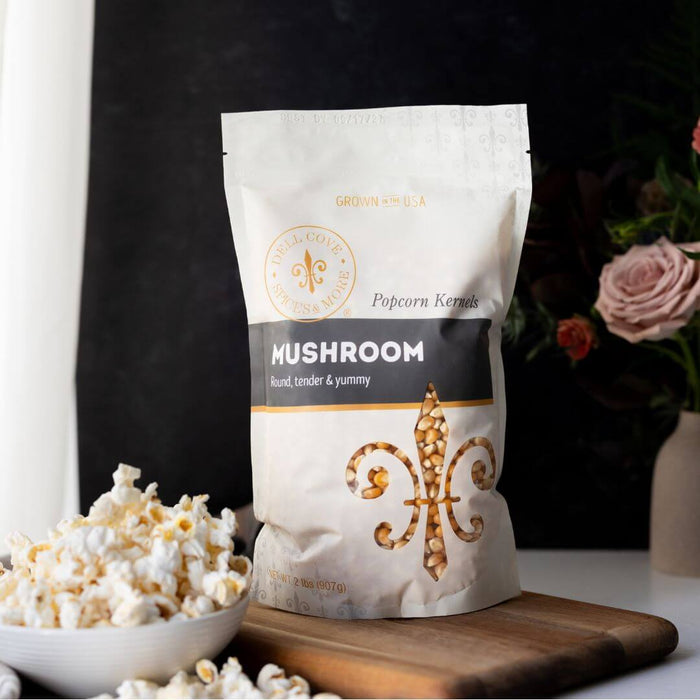 Dell Cove Extra Large Mushroom popcorn kernels with a bowl of popped popcorn