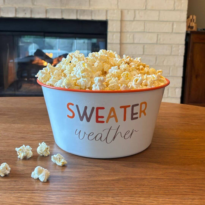 Sweater Weather enamel popcorn bowl filled with popcorn for a cozy fall movie night