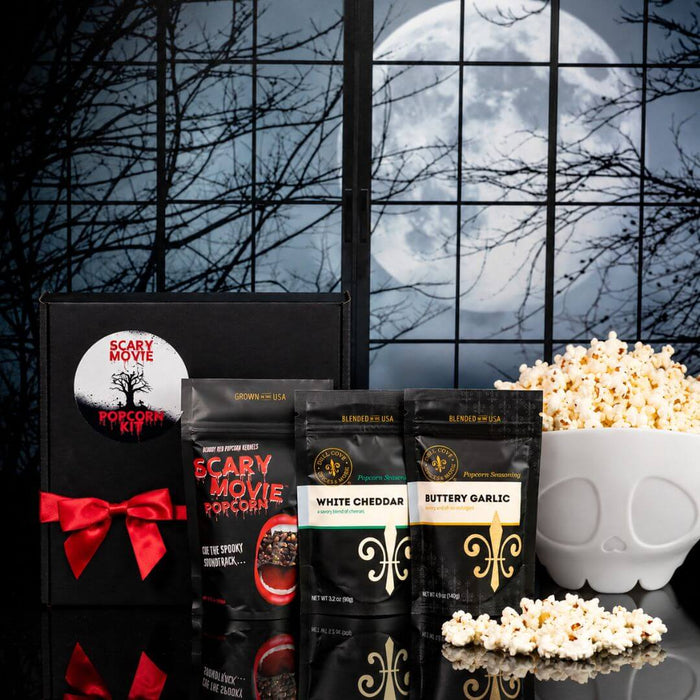 Scary Movie Vampire Halloween popcorn gift kit with Bloody Red popcorn kernels, two gourmet seasonings, black gift box with red ribbon and white skeleton-shaped microwave popcorn popper.