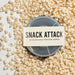 Snack Attack silicone microwave popcorn popper in packaging surrounded by freshly popped popcorn