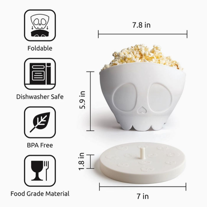 White skull-shaped popcorn bowl with measurements and features on a white background