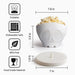 White skull-shaped popcorn bowl with measurements and features on a white background
