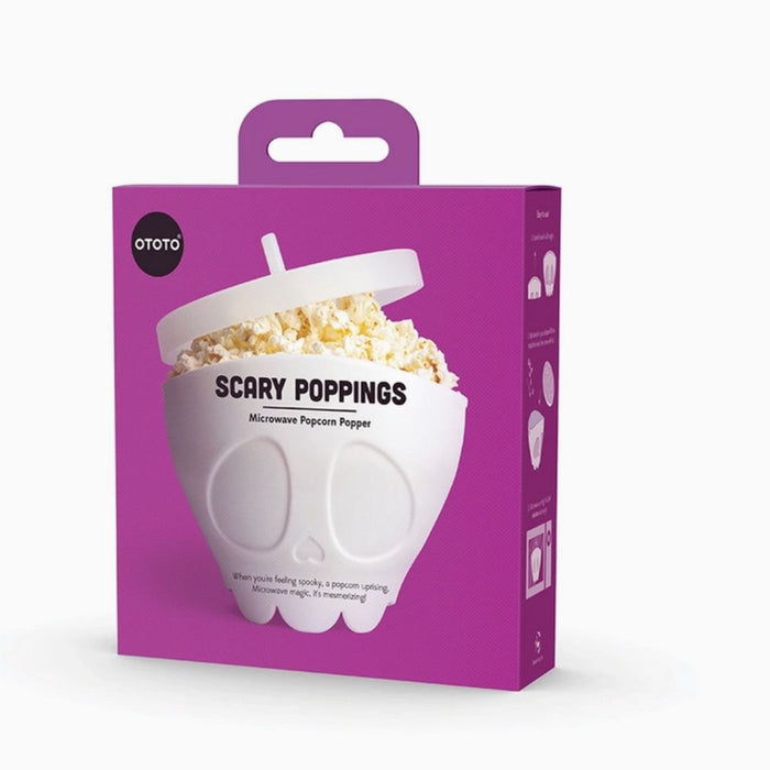 Purple packaging of a microwave popcorn popper with 'Scary Poppings' text and 'Ototo' branding. Skeleton popcorn popper used for spooky movie night.