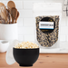 Midnight blue popcorn kernels pouch with popcorn popper full of popped popcorn - dell cove spices