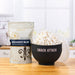 Dell Cove Midnight Blue popcorn kernels beside a black Snack Attack microwave popcorn popper filled with freshly popped popcorn.