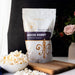 Dell Cove Movie Night yellow butterfly popcorn kernels with a bowl of popped popcorn