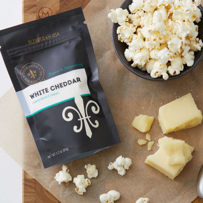 Gourmet popcorn seasoning choices such as White Cheddar are included in Dell Cove® Personalized Snack Gift Set.