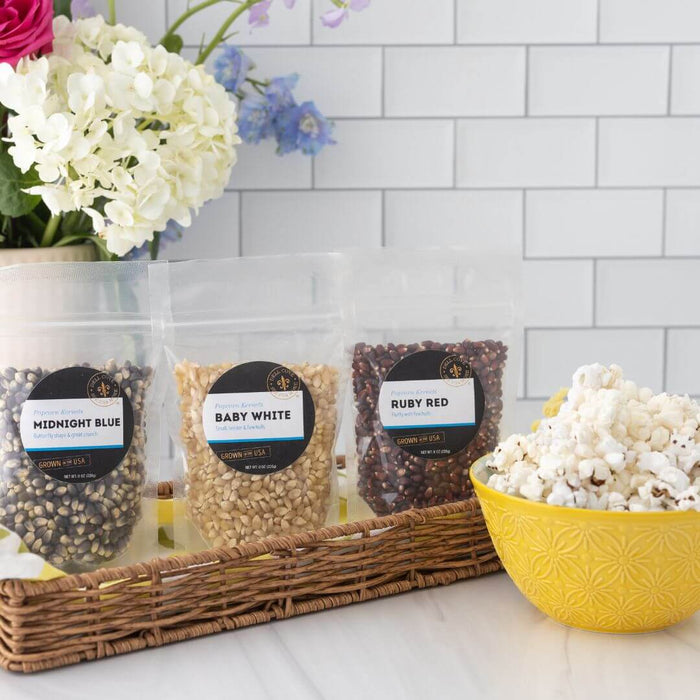 Midnight Blue, Baby White and Ruby Red popcorn kernels with popped popcorn