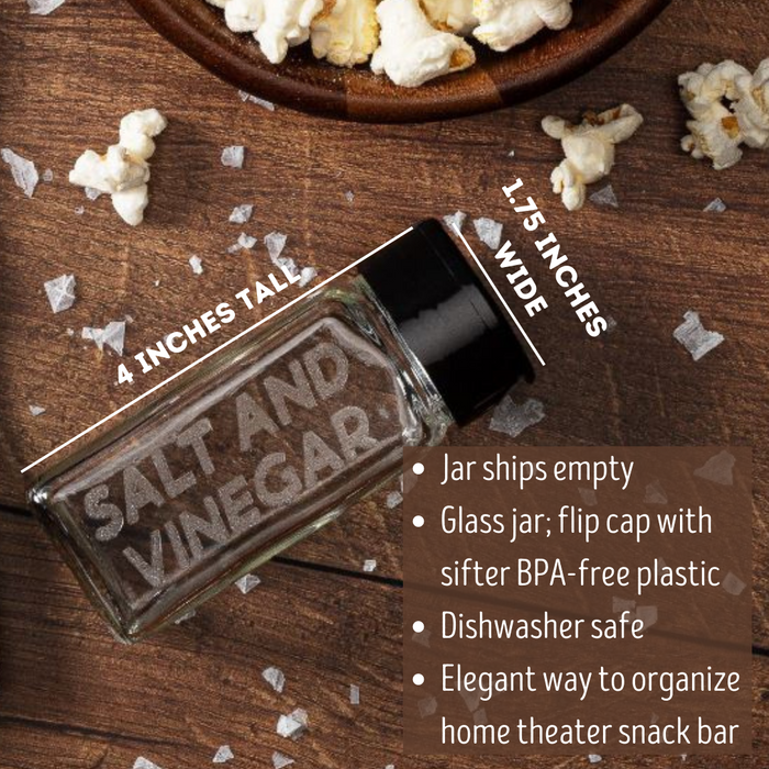 empty glass spice jar with black flip cap with popcorn seasoning flavor salt and vinegar etched on one side and bowl of flavored popcorn - dell cove spices