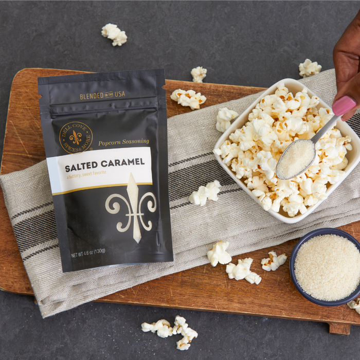 Salted Caramel popcorn seasoning pouch with bowl of popcorn and hand holding spoon - dell cove spices