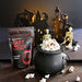 Scary Movie Popcorn packaging with a black cauldron filled with popcorn against a Halloween-themed background.