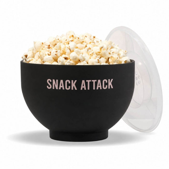 Black silicone microwave popcorn popper filled with popped popcorn with clear measuring lid