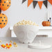 Skeleton microwave popcorn popper filled with fluffy popcorn