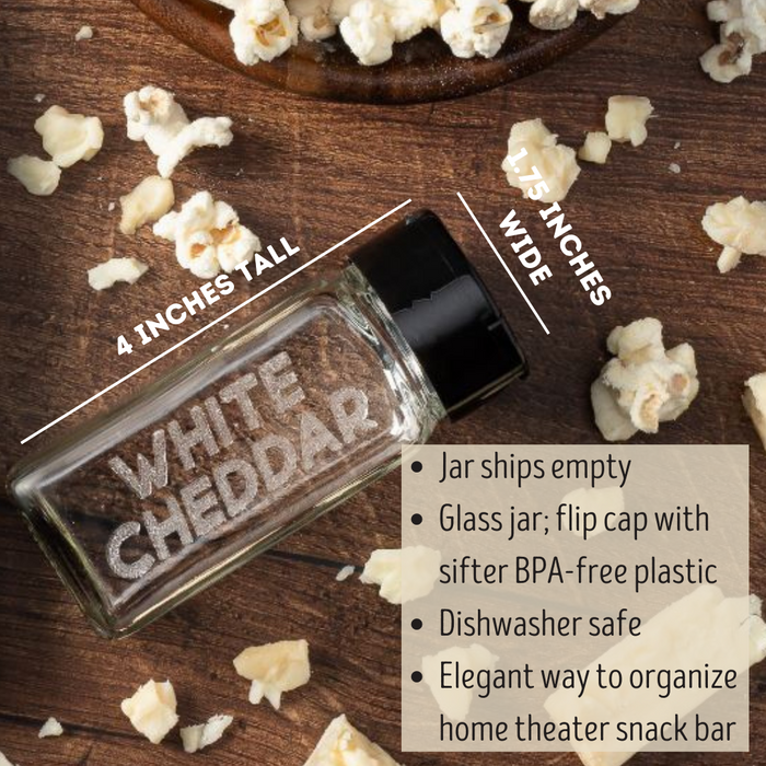 empty glass spice jar with black sifter cap laser etched with the popcorn seasoning flavor WHITE CHEDDAR on one side and popcorn and chunks of white cheddar cheese - dell cove spices