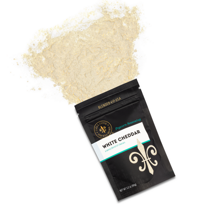White cheddar popcorn seasoning front pouch spill - dell cove spices