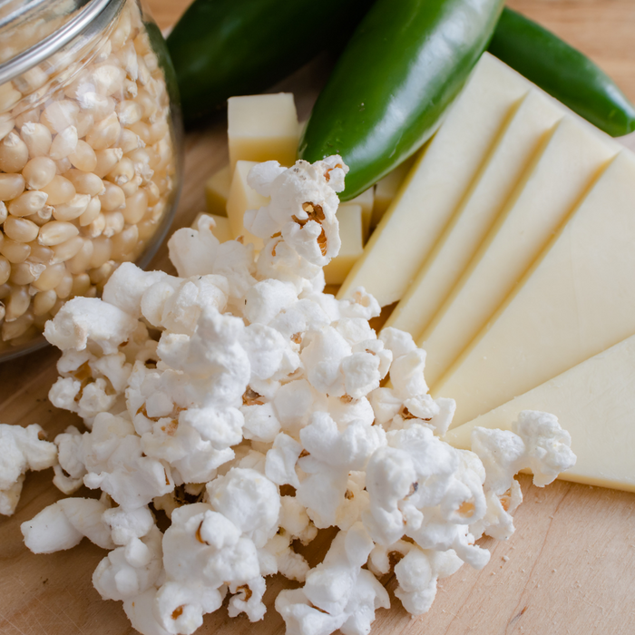 White Cheddar Jalapeno popcorn seasoning on popcorn with cheese and jalapenos - dell cove spices